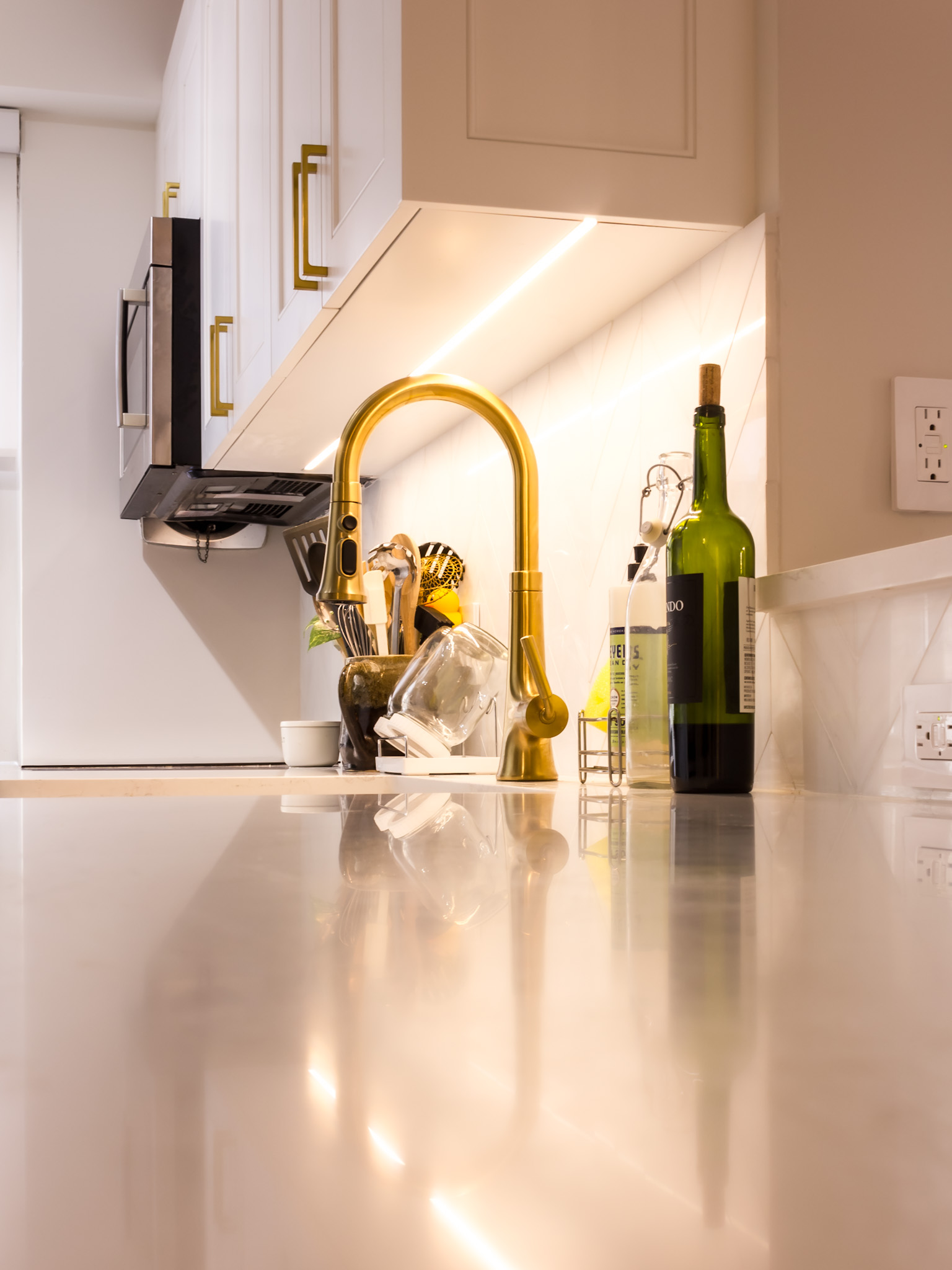 Brass faucet and quartz countertop detail